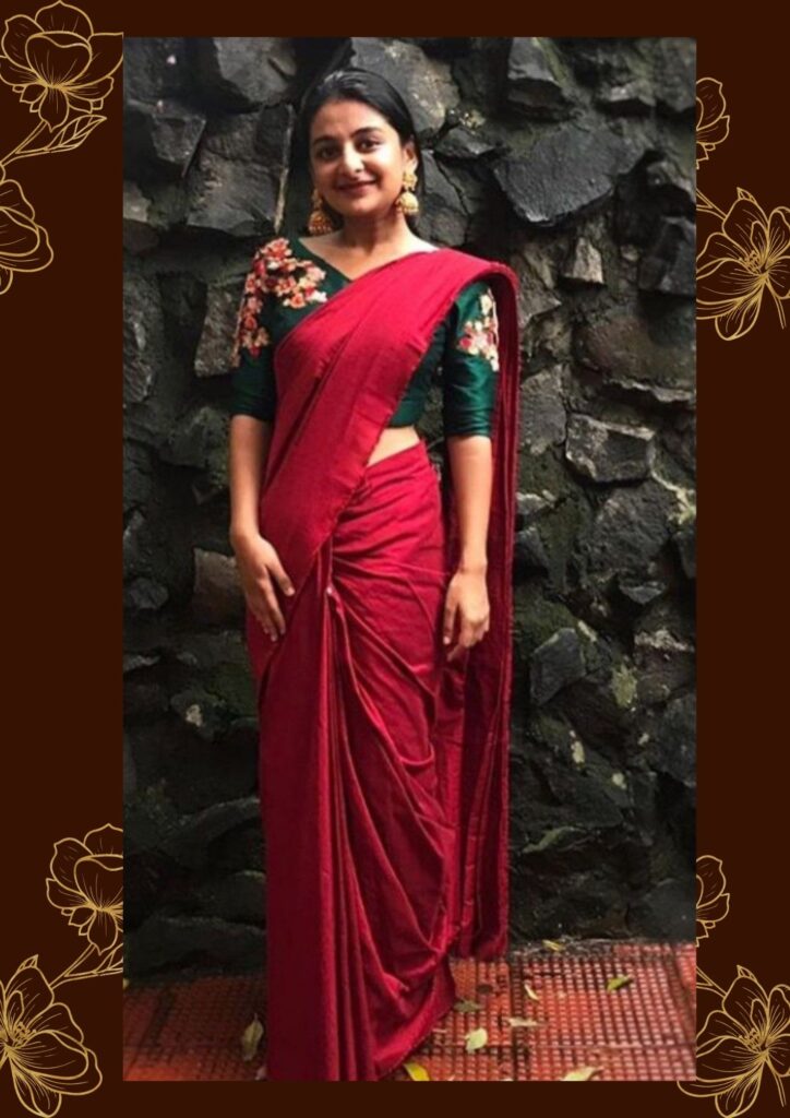 model wearing maroon saree with green blouse