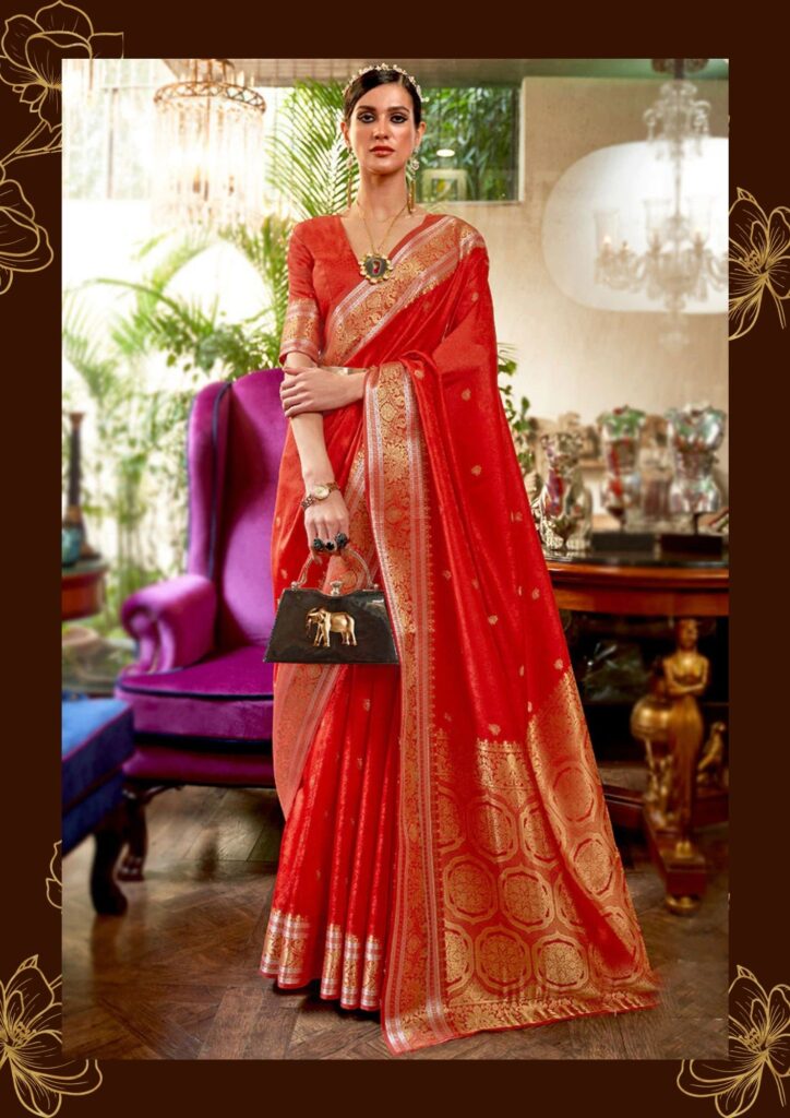 model wearing red colour saree with bag